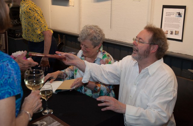 Linda (left) and Michael Hutcheon signing their book for an eager audience.